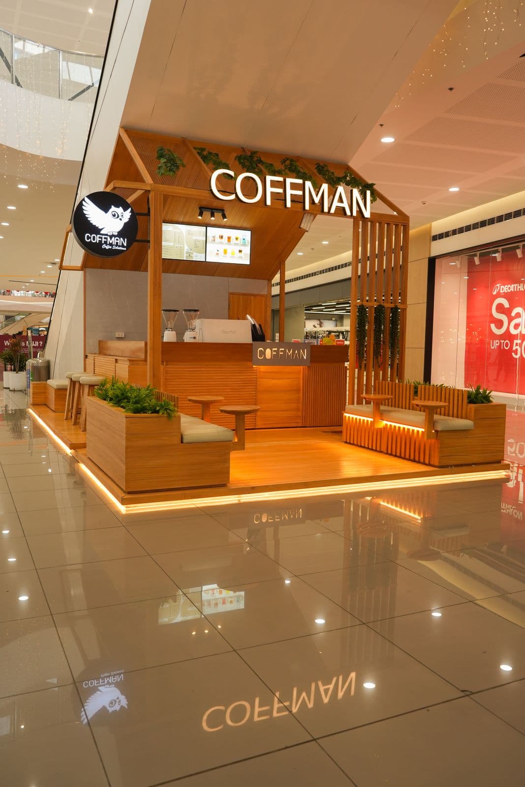 Coffman Coffee kiosk side view with slatted wood panels and integrated LED underlighting