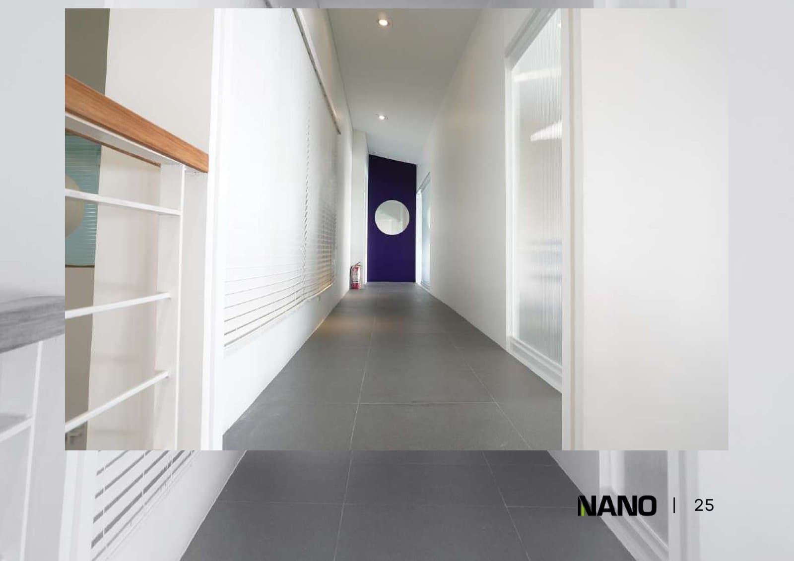 Office hallway with clean white walls and warm timber accent paneling