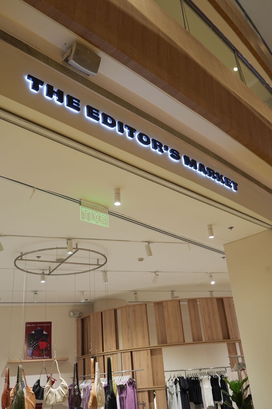 The Editor's Market fitting room area with arched entrances and curtain drapery