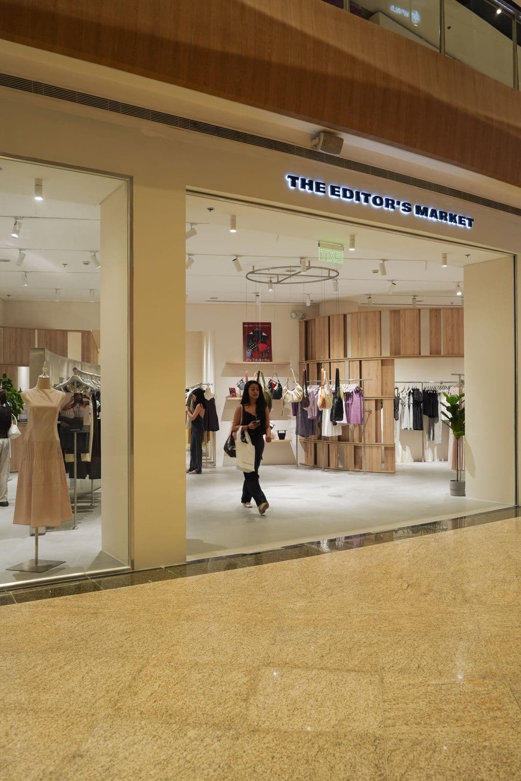 Wide view of The Editor's Market storefront in mall setting